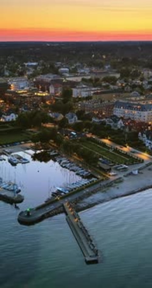 Aerial drone view of Osterbo Nord, Nordhavn harbour area at the coast of the Oresund at sunset. Vert