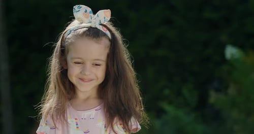Smiling Young Girl With Bunny Ear Headband Outdoors