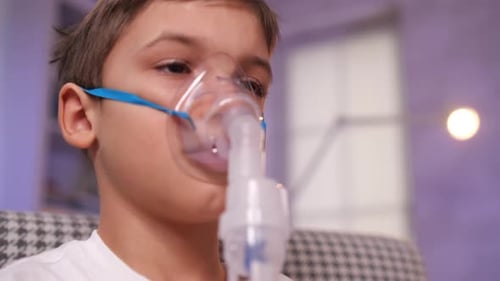 Young Boy Wearing Nebulizer Mask for Treatment