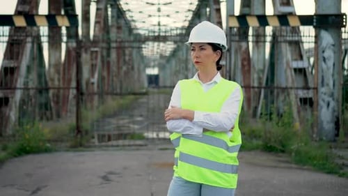 Portrait Woman Industrial Engineer in White Hard Hat Highvisibility Vest Safety Supervisor on Bridge