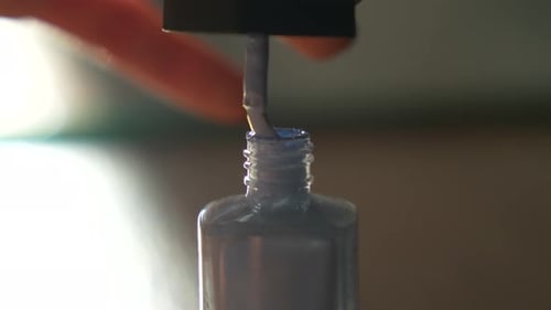 Close-up of blue nail polish bottle