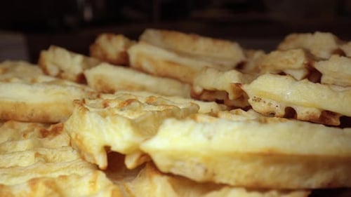 Stack of fresh golden waffles hot and ready to eat - sliding isolated close up