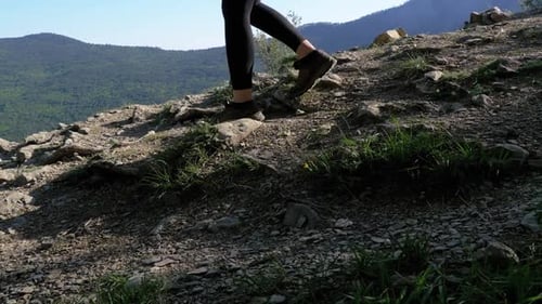 View on Feet of Traveler Woman Hiking Walking on the Top of Cliff in Mountain Walking on Rocks