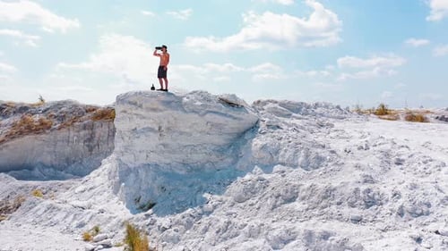 Brutal strong bodybuilder pumping up muscles. Bodybuilding and outdoor sports concept. Aerial view.