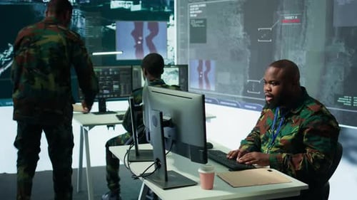 Military Team in a Control Center Uses Advanced Technology to Gather Information