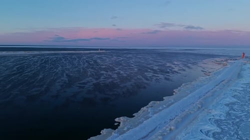Ice Coastline Meets Open Water Twilight Illuminates Glacial Shore Contrasting with Shadowy Ocean