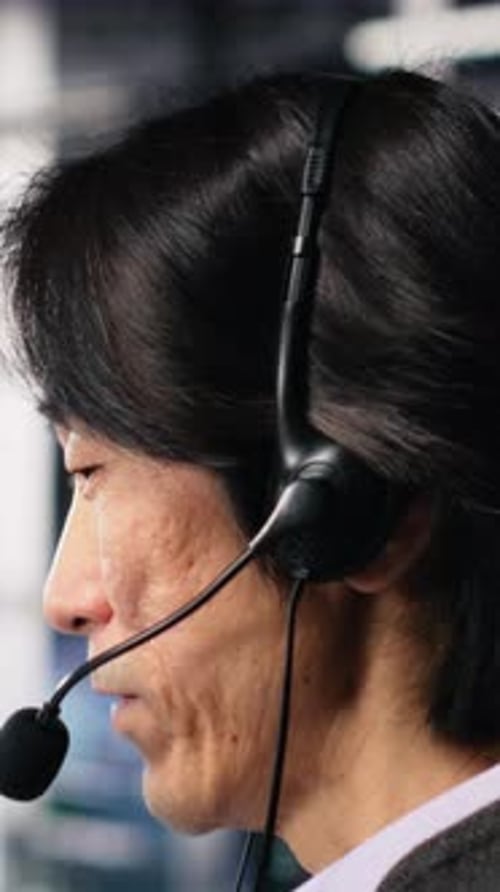 Vertical Video Engineer in Data Center Wearing Headset Assisting Users with AI