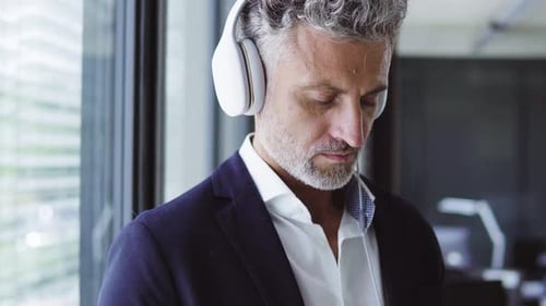 Man with Headphones in Modern Office