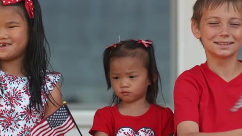 Children Waving American Flags for Holiday Celebration