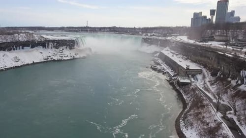 Horseshoe Falls at Niagara Falls in snowy winter, wide aerial push-in