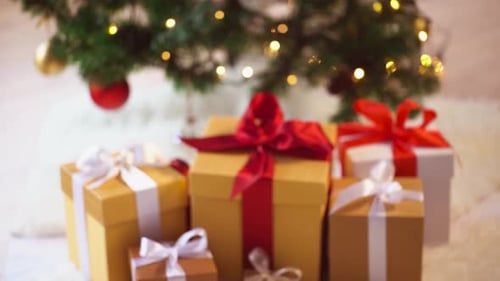 Christmas presents under an illuminated Christmas tree