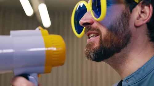 Man Shouting into Megaphone Wearing Sunglasses