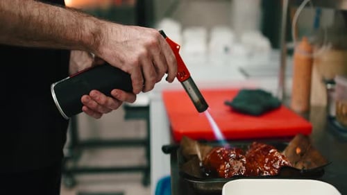 Chef Using Blow Torch to Prepare Food