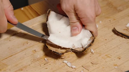 Close Up Cutting Coconut on Wood Board