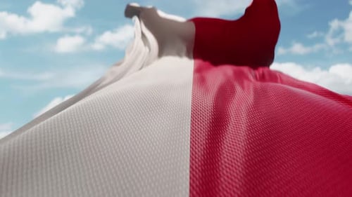 Waving Flag with White and Red Stripes Against Blue Sky