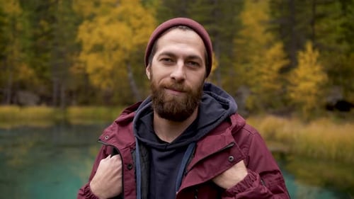 Bearded Man Relaxing in Front of Autumnal Lake