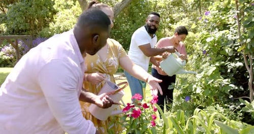 Friends Watering Flowers in a Lush Garden