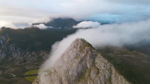 Clouds Moving Over mountain peaks and between Mountains With sunset in the background. Viewpoint In