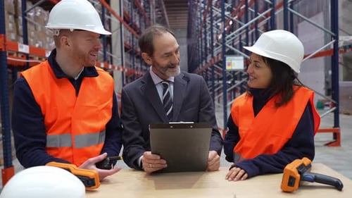 Warehouse Workers Discussing Logistics with Manager