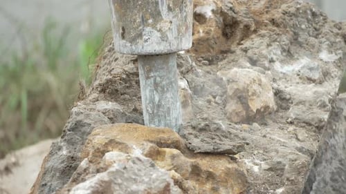 Demolition Concrete Breaking Large Rocks at Construction Site for Urban Development