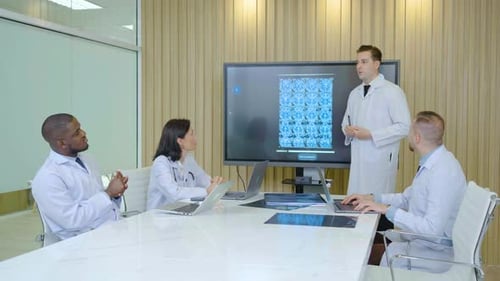 Medical Professionals Reviewing X-ray in Meeting Room
