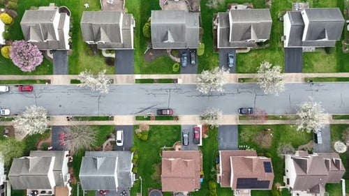 American suburban neighborhood homes. Top down aerial truck shot during beautiful spring day with bl