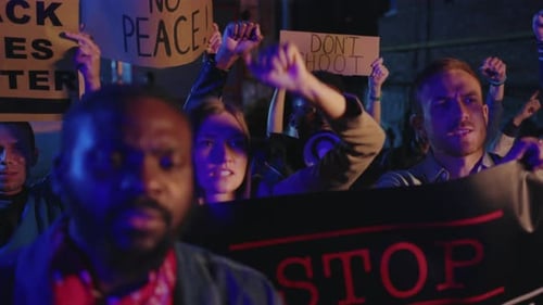 Diverse Group Protesting with Signs at Night