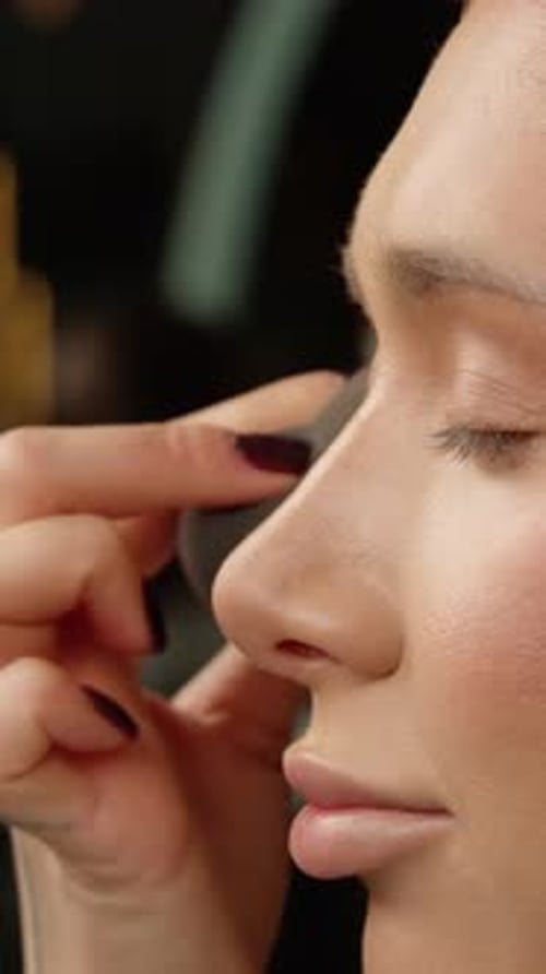 Model Receiving Makeup with Sponge Applicator Close Up