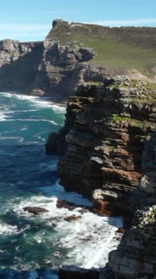 Vast Rocky Coast With Powerful Surf Majestic Rugged Coastlines With Crashing Waves And Blue Sky