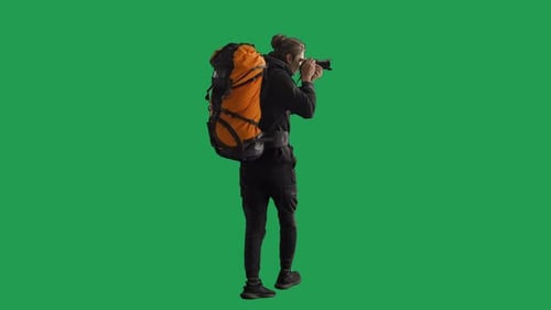 Back View of a Male Traveler Taking Photos on a Camera During a Hike Man Hiker in Full Length