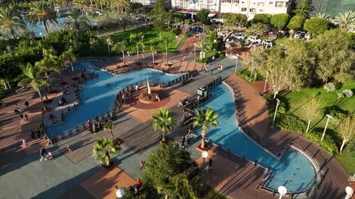 A Park and a Large Recreation Area Playgrounds Basketball and Tennis Courts Fountains Palm Trees a