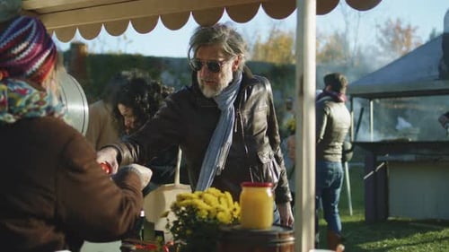 Adult Buys Apples at Outdoor Market