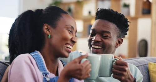 Happy Young Couple Snuggling and Drinking Coffee