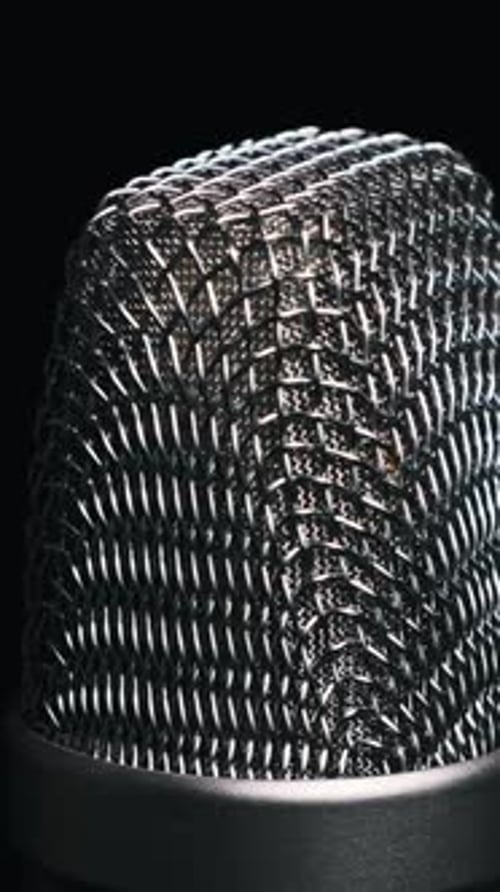 Studio Microphone Rotates on a Black Background CloseUp