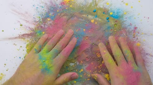 Hands Spread Vibrant Holi Powder on White Background