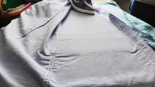 Closeup Of An Iron Using Steam Ironing Clothes And Things Slowmotion Video.