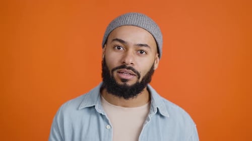 African American Man Presses Palm to Face with Annoyance