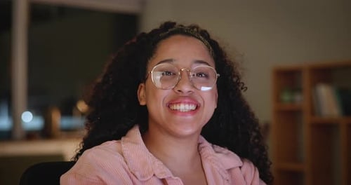 Smiling Woman With Glasses Indoors at Night
