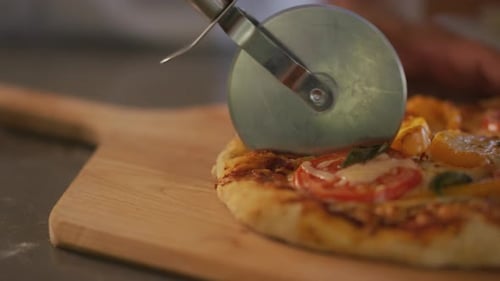Cutting Pizza Into Slices. Close Up