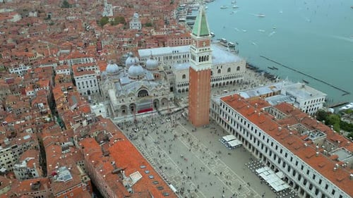 4K Aerial of San Marco, the Rialto Bridge, and the canals in Venice, Italy on a cloudy day.