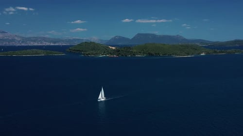Sailboat Cruising Near a Tranquil Island on a Sunny Day