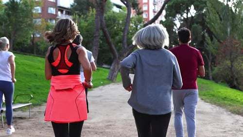 Group of People Running in Park for Healthy Lifestyle