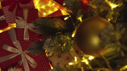 Christmas Presents Under the Tree with Twinkling Lights