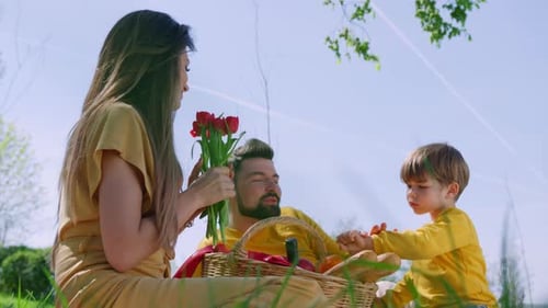 Family Picnic with Flowers on a Spring Day