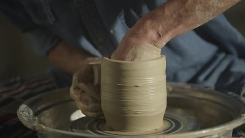 Closeup of a Potter's Hands Working with Clay on a Potter's Wheel in a Workshop