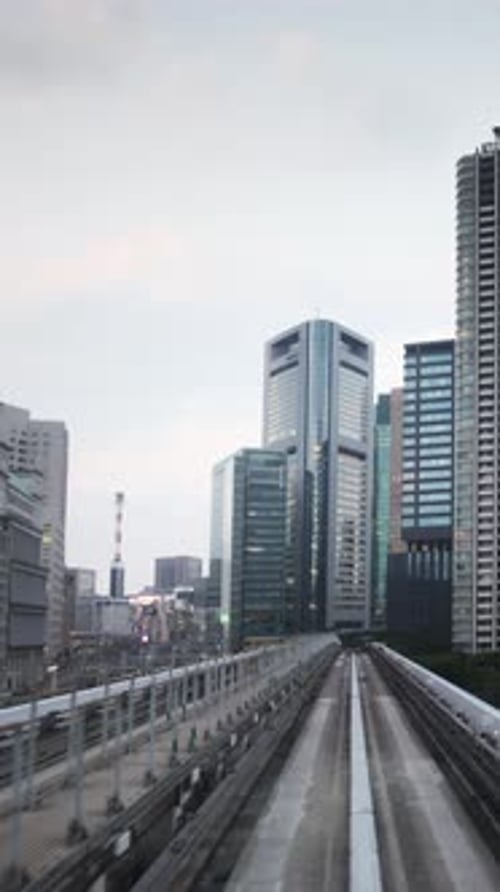 Tokyo Monorail Passing Through the City's Skyscapers in Vertical