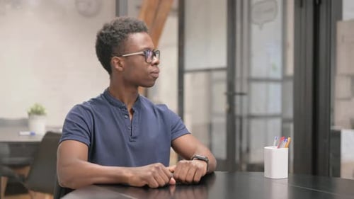 Man Waiting While Looking at Watch in Office