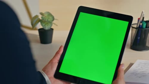 Woman Holds Tablet with Green Screen in Office