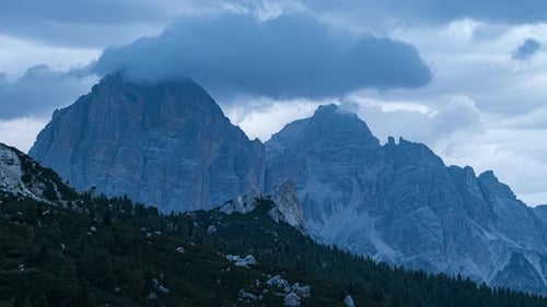 Moody feel in Dolomite mountains with flowing clouds, time lapse