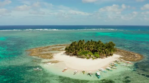Tropical Guyam Island with a Sandy Beach and Tourists